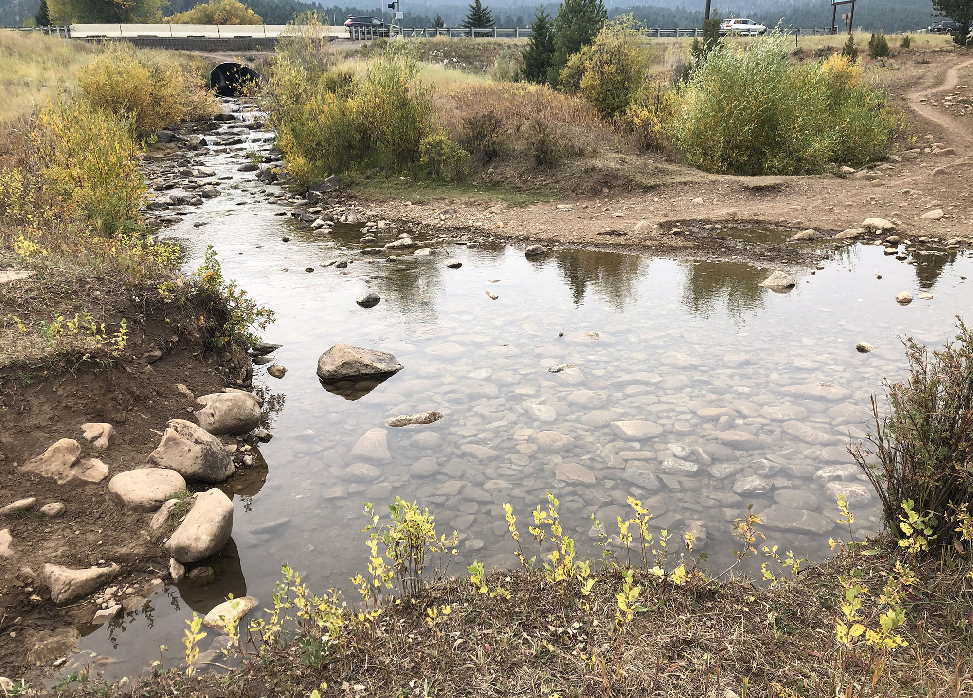 The culvert at the highway intersection is a fish barrier and the stream crossing is showing evidence of recreational use impacts including soil erosion, compaction, and damage to vegetation.